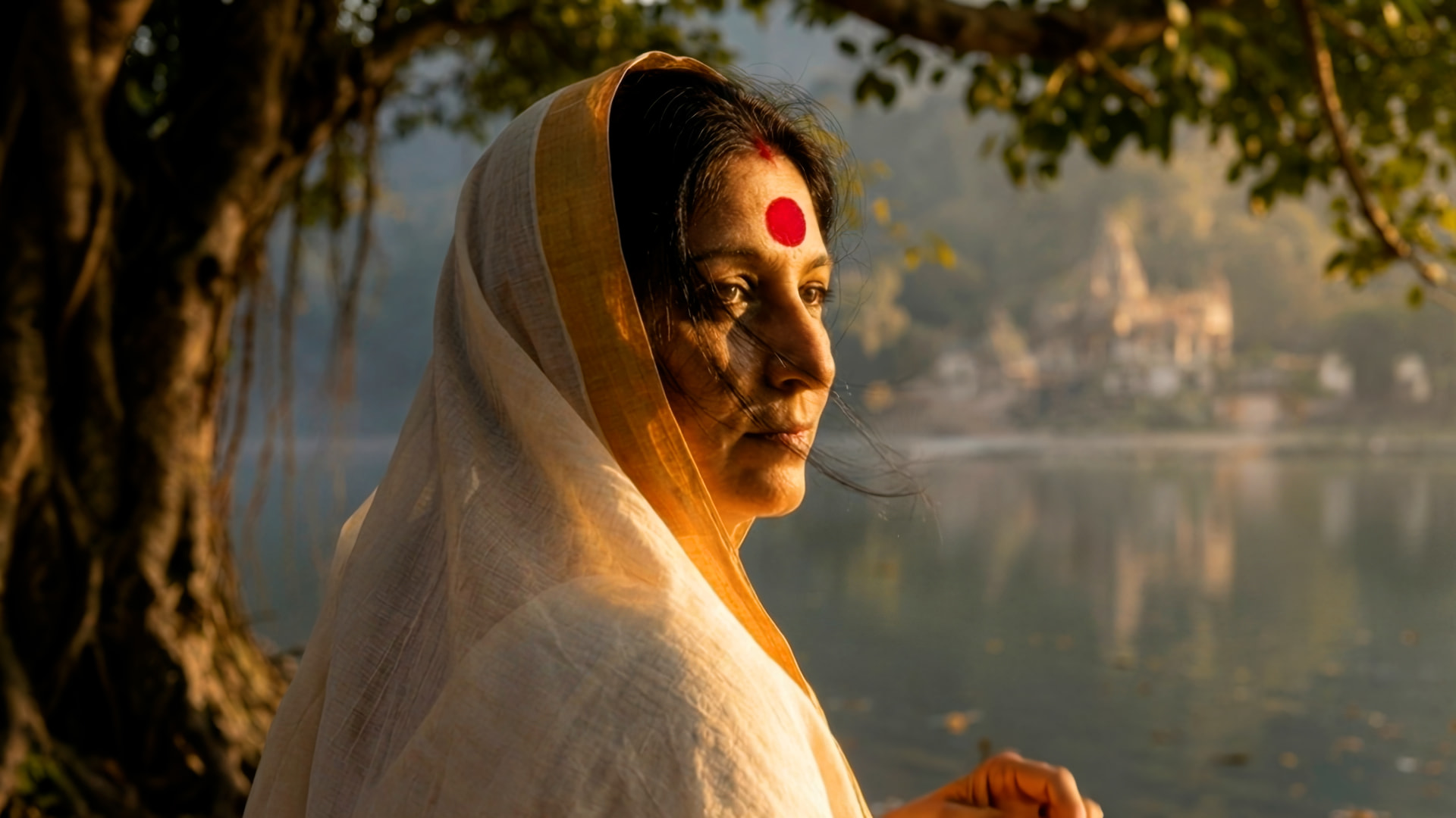 Meera in a white and gold sari lit by warm evening light